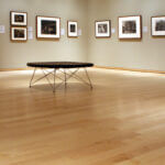 Hardwood Flooring in an empty gallery and a table in the middle