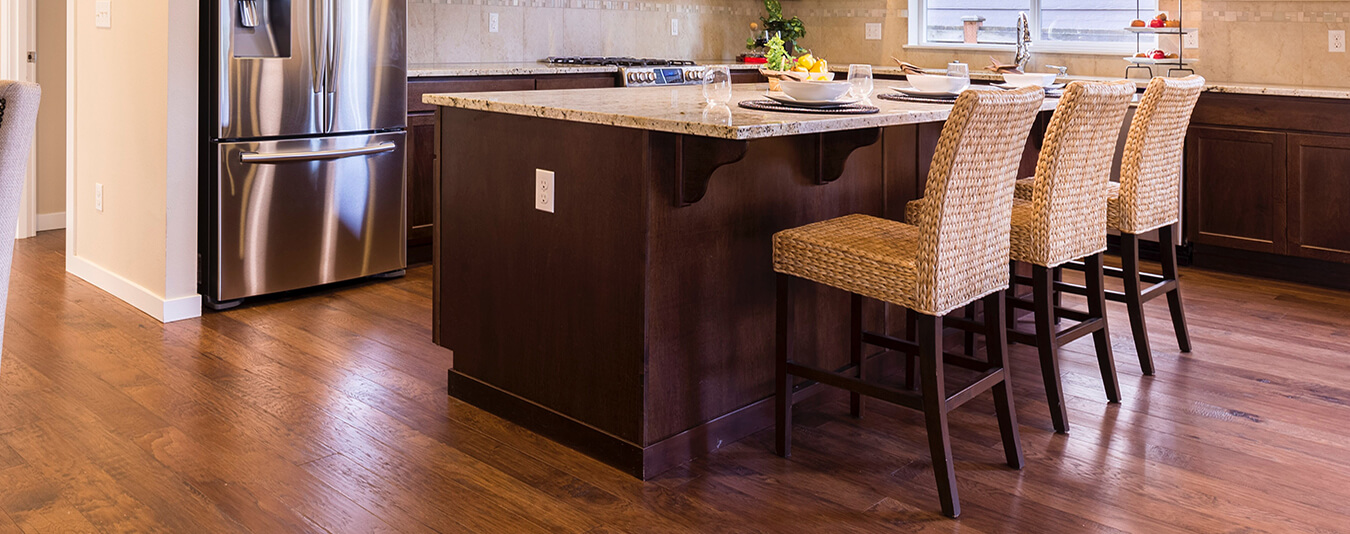 The hardwood floor refinishing process begins with assessing the damages and proceeding with necessary repairs.